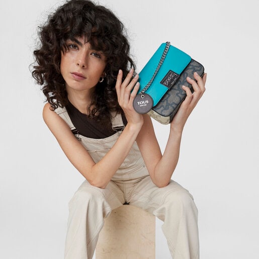 ブラック＆ターコイズカラーのスモールクロスボディバッグ Kaos Legacy